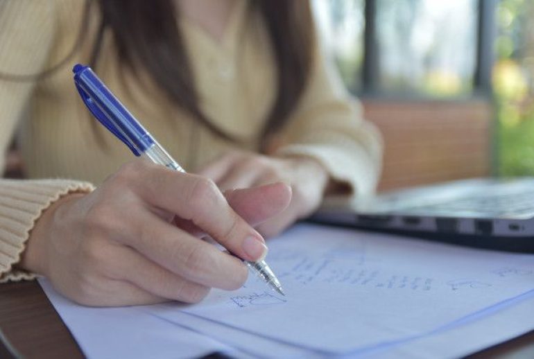 Person writing on papers _ Premium Photo Person writing on papers _ Premium Photo